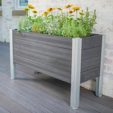 Raised garden planter with dark gray slatted sides and light gray metal legs