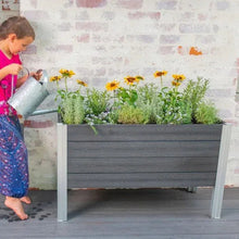 Elevated garden planter with yellow flowers and green foliage for outdoor planting