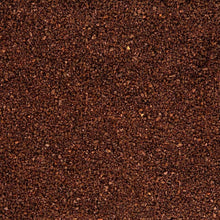 Ground coffee close-up, dark brown fine grounds texture