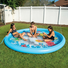 Inflatable under-the-sea splash pad with blue rim, kids playing as water sprays