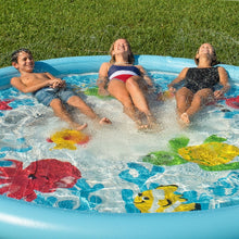 Inflatable under-the-sea splash pad with kids splashing water inside blue pool