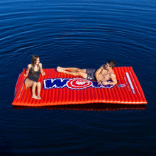 WOW Sports red inflatable water walkway on open water, people lounging