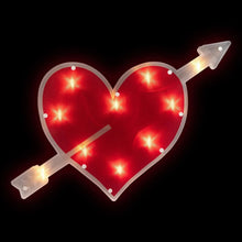 Lighted heart window silhouette with red interior, white border, and two crossed arrows