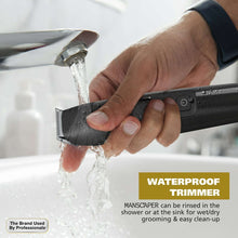 Black waterproof body groomer rinsing under running water for easy cleaning