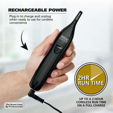 Black rechargeable detail trimmer being charged with power cord