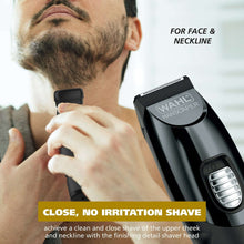 Facial grooming trimmer with guard, held against stubble on chin and neck