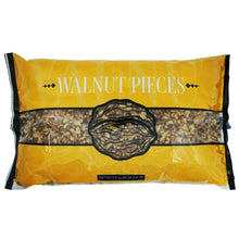 Walnut pieces in a sealed pouch, with dark pieces visible through clear window