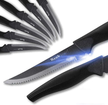 Serrated steak knife with black handle and shiny steel blade