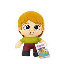Shaggy plush toy with blonde hair, green shirt, maroon pants and friendly face