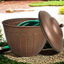 Garden water hose storage pot with open lid and green hose coil inside the embossed bucket