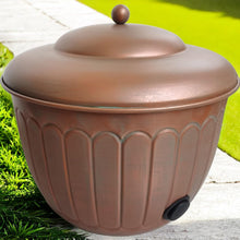 Garden water hose storage pot with domed lid knob, embossed copper sides, and hose connector port