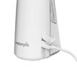 White cordless water flosser base with charging cord plugged in.