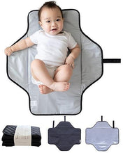 Foldable changing pad with dark trim and baby, light gray fabric