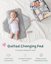 Quilted foldable changing pad with a baby, light gray with black trim