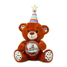 Tan bear plush upright, rainbow party cone hat and glowing music globe on chest.