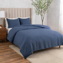 Blue cotton-linen relaxed duvet cover set with matching pillow shams, on a bed