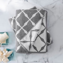 2-pack jacquard bath towels in gray with white diamond lattice, one towel folded over