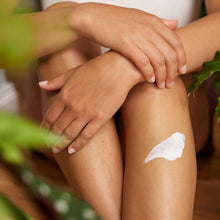 Weleda Skin Food cream applied to legs and rubbed in with hands.