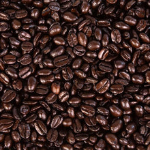 Dark roast whole coffee beans close-up, glossy brown coffee grounds
