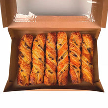 Six chocolate Bavarian twists in open cardboard box, with dark chocolate flecks