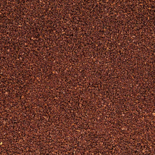 Ground coffee texture with dark brown granules