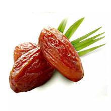 Pile of dried pitted dates, wrinkled reddish-brown fruit pieces with stems
