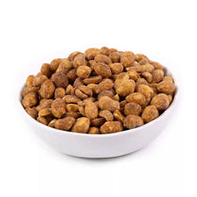 Honey-roasted peanuts in a white bowl, coated with seasoning