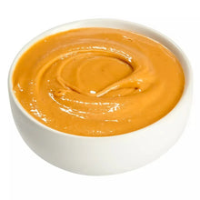 Bowl of creamy peanut butter with smooth, glossy spread