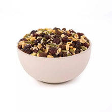 Organic trail mix in white bowl filled with nuts, seeds, and dried fruit