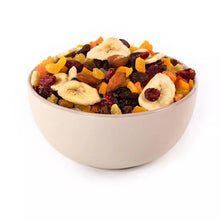 Bowl of dried tropical harvest mix fruit: bananas, mangos, cranberries, almonds