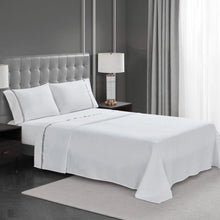 White 4-piece sheet set on a bed with pillowcases and flat top sheet