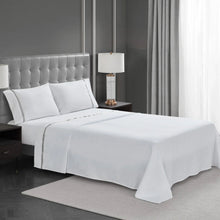 White 4-piece sheet set on bed with top sheet and ribbon hem edge