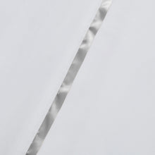 White sheet edge with satin ribbon hem detail