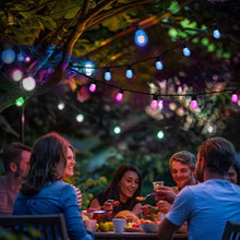 Outdoor solar LED string lights with multicolor bulbs along a garden walkway