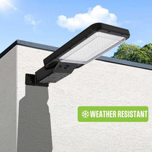 Wall-mounted solar motion-activated area light with rectangular LED panel, black housing