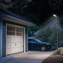 Solar area light fixture with rectangular LED panel, mounted on a black wall bracket