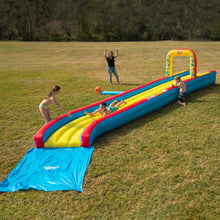 Inflatable slip 'n slide with blue red and yellow lanes, tube-style entry arch
