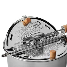 Close-up of the stainless steel Whirley Pop lid, stirring mechanism, and wooden knobs
