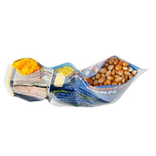 Opened popcorn kit bag showing separate kernels, popping oil, and buttery salt