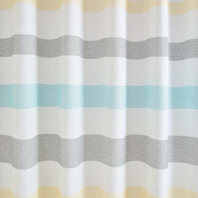 Close-up striped shower curtain fabric with wavy bands in blue and gray