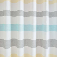 Shower curtain fabric close-up with wavy stripe bands in blue and yellow