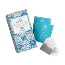 Earl Grey tea bag sachets with paper filter tags and blue patterned packaging