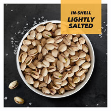 Bowl of in-shell lightly salted pistachios with visible green kernels and shells