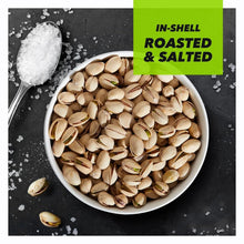 In-shell roasted salted pistachios in a bowl with scattered shells