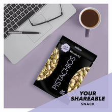 Wonderful Pistachios salt & pepper pouch near laptop and coffee cup