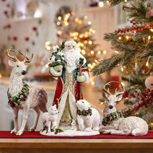 Woodland deer figurines on red base, including standing deer with green berry wreath.