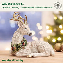 Resting deer figurine with detailed fur texture and a green berry wreath across its chest.