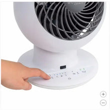 White globe fan with touch control panel, finger pressing the buttons