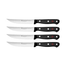 4-piece steak knife set with black handles and silver blades, staggered lineup