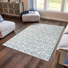 Indoor area rug corner with light blue and white ornate motif, flat woven look